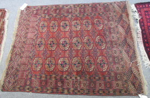 A Tekke Turkman rug, the madder field with three columns of six guls, supporting crosses, a sunburst border, 150cm x 116cm, and a Tekke Turkman rug, t