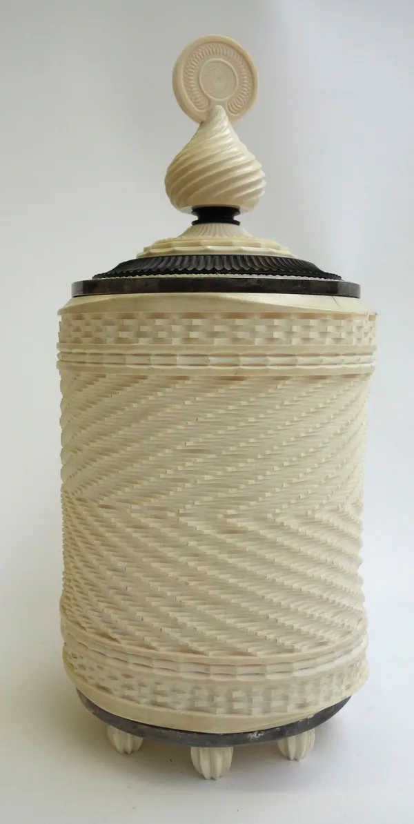 A cylindrical ivory box, probably Ceylon, India, late 19th century, with all over carved decoration and wooden lid, (a.f), 25cm high.