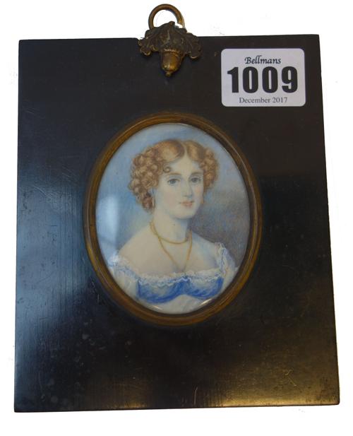 A mid-19th century English School portrait miniature on ivory of 'Miss Danby', her hair in ringlets, with gold necklace and white lace trimmed dress,