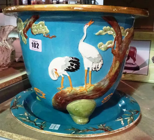 A Minton blue ground jardiniere, and a matching stand/dish decorated with flora and fauna, (2).  S2