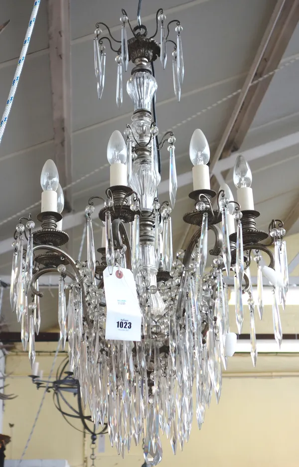 A late 20th century white metal and glass mounted eight branch chandelier, the central glass stem hung with glass lustres and drops over four tiers, i