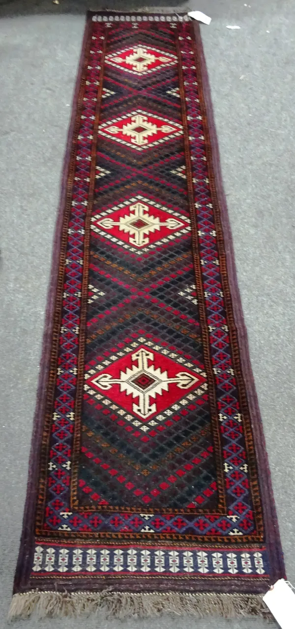 A Turkeman rug, the ivory field with two columns of seven madder guls, multi borders, 161cm x 104cm, and a Beluchistan runner, with four flatweave dia