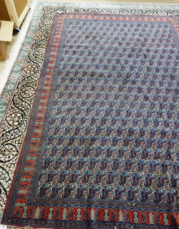 A West Persian carpet, with repeat botch field and narrow red ground boteh border, 212cm x 317cm.