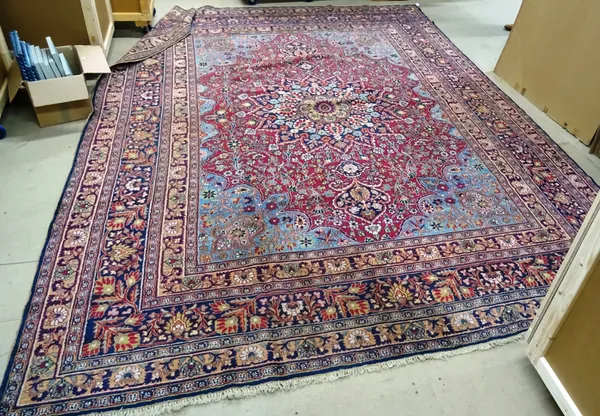 A Doroksh carpet with plum field and central medallion, light blue spandrels and banded border, 320cm x 412cm.