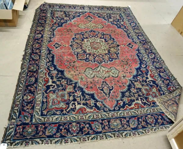 A Hamadan carpet, first half 20th century, with pink lozenge shaped field and blue medallion, 231cm x 327cm, (a.f).