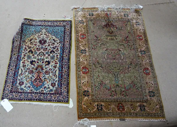 A Hereke silk rug, early 20th century, the pale green field with vase, flowers and birds, signed, 88cm x 134cm, together with an Isfahan prayer mat, w
