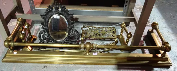 An Edwardian brass fender with assorted fire irons, and a cast iron framed small mirror, (qty).  I3