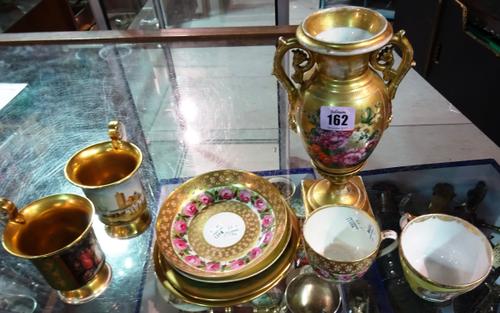 A Paris porcelain two handled vase of urn form, 19th century, hand painted with still life flowers, (24cm high), a Berlin pink ground cabinet cup and