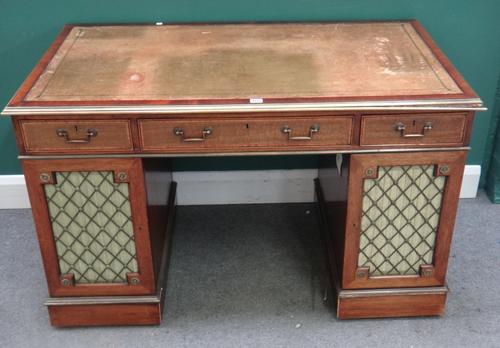 A 19th century and later brass mounted mahogany pedestal desk, with three frieze drawers over grille fronted pedestals, 123cm wide x 78cm high x 70cm
