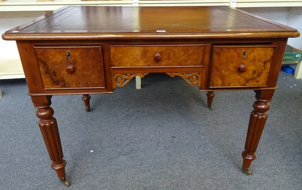 A Victorian figured walnut writing desk, the leather inset top over three frieze drawers, on reeded supports, 108cm wide x 77cm high x 82cm deep.