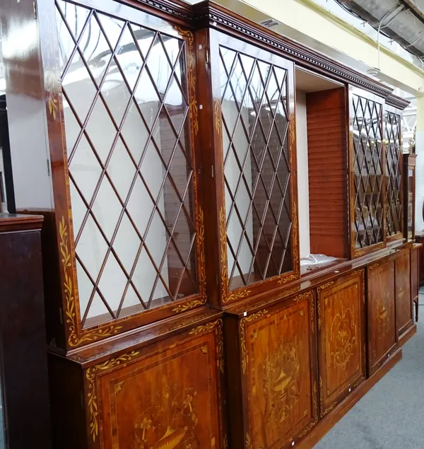 A George III floral marquetry inlaid mahogany breakfront bookcase, with five glazed upper doors over five panel lower, on plinth base, 249cm high x 37