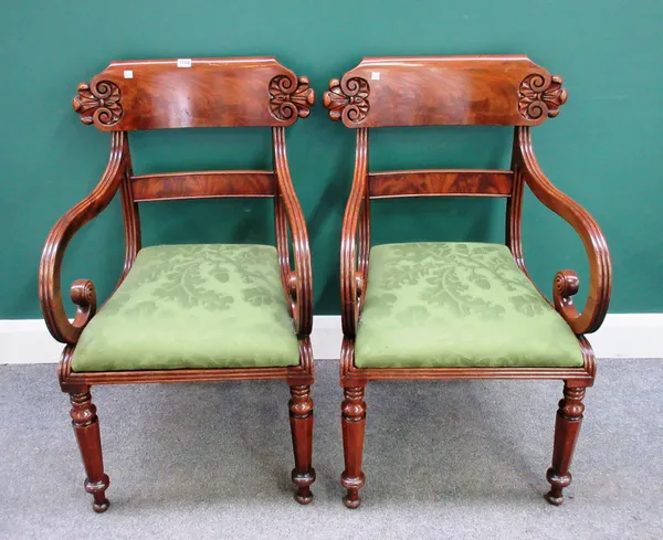 A pair of mid-19th century mahogany framed open armchairs, each with carved crest rail, on tapering octagonal supports, 54cm wide x 91cm high, (2).