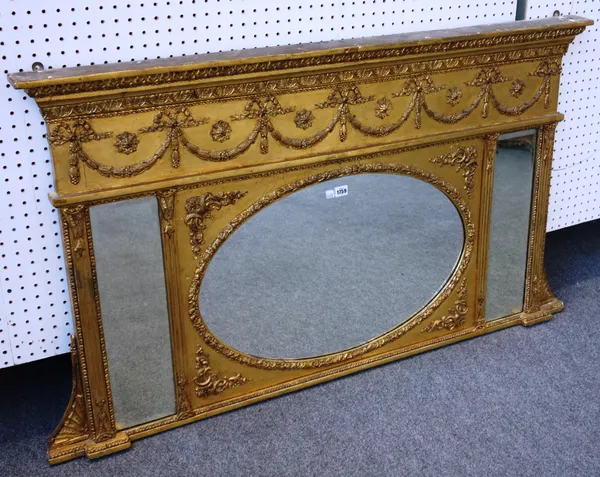 A late 19th century Adam Revival gilt framed overmantel mirror, with ribbon tied swag frieze and oval plate, 141cm wide x 81cm high.