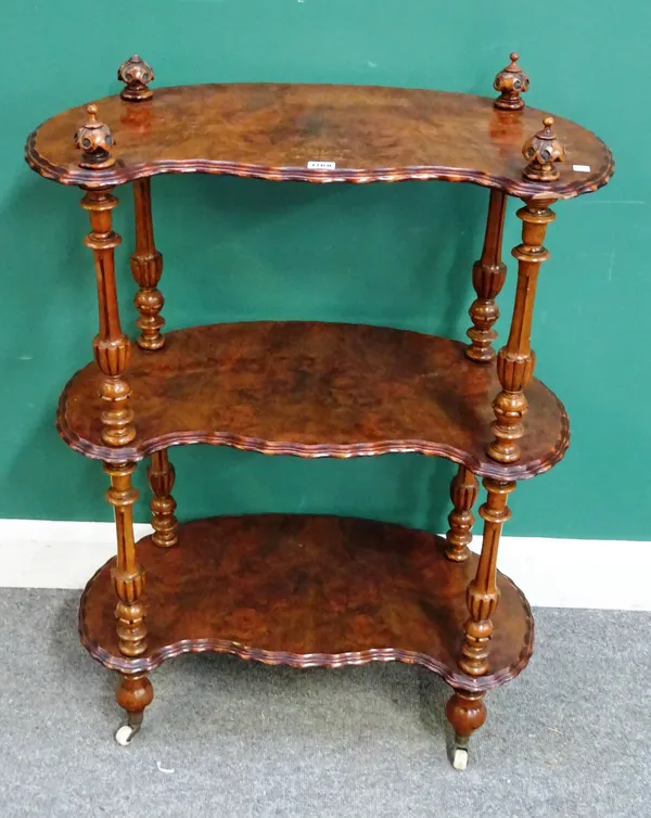 A Victorian marquetry inlaid figured walnut shaped three tier whatnot, on fluted supports, 74cm wide x 104cm high x 40cm deep.