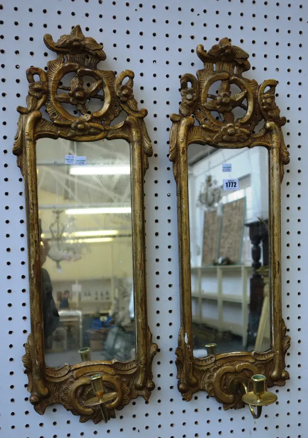 A pair of 18th century Continental gilt framed girandole wall mirrors with pierced and carved floral crest, 25cm wide x 75cm high