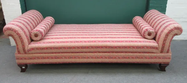 A large 20th century day bed, with double rollover ends, on squat sabre supports, 250cm wide x 77cm high x 93cm deep.