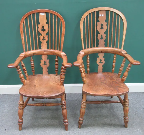 A pair of early Victorian style ash and elm Windsor chairs, with solid seats and turned supports, 66cm wide x 118cm high.