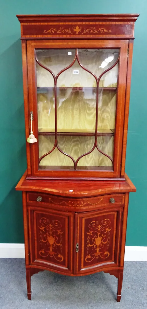 In the manner of Edward & Roberts; a late 19th century satinwood banded marquetry inlaid mahogany display cabinet cupboard, the single glazed door ove