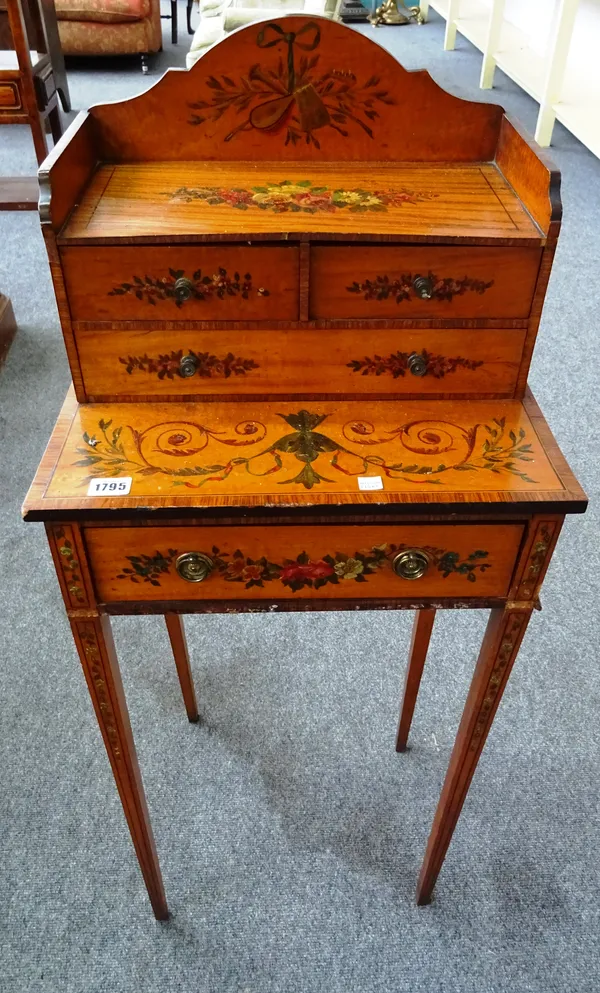 A late Victorian floral painted rosewood banded satinwood cheveret, with four drawers, on tapering square supports, 43cm wide x 106cm high x 34cm deep