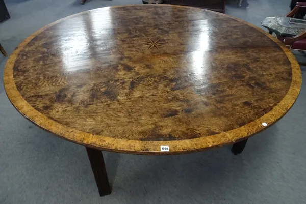 An 18th century style pollard oak centre table, the circular top with star burst inlay, on four channelled square supports, 183cm diameter x 75cm high