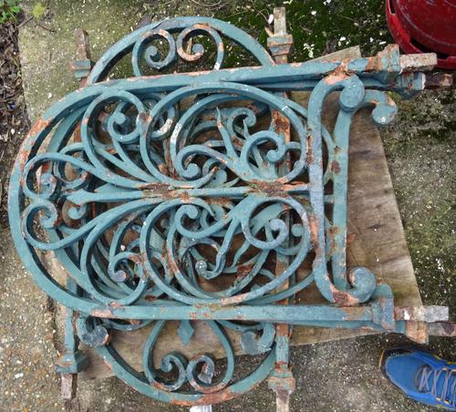 Four sections of 19th century green painted cast iron railings, with stylized fleur de lys decoration, each 218cm wide x 65cm high, together with four