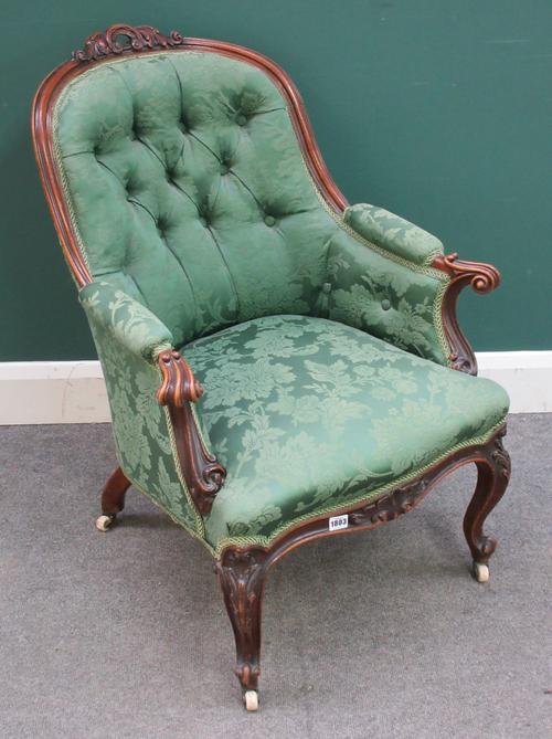 A Victorian walnut framed tub back easy armchair, with serpentine seat and scroll supports, 69cm wide x 89cm high x 75cm deep.