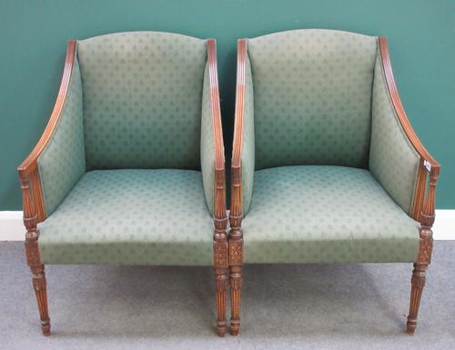 A pair of Regency style mahogany framed square back armchairs,with downswept arms on reeded supports, 66cm wide x 97cm high.