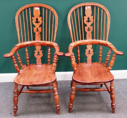 A pair of early Victorian style ash and elm Windsor chairs, with solid seats and turned supports, 66cm wide x 118cm high.