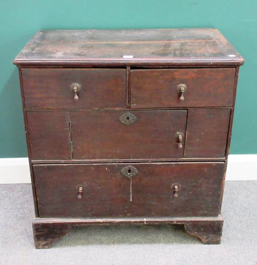 A small 18th century oak chest with two short and one long drawer about central cupboard, 76cm wide x 80cm high x 44cm deep.