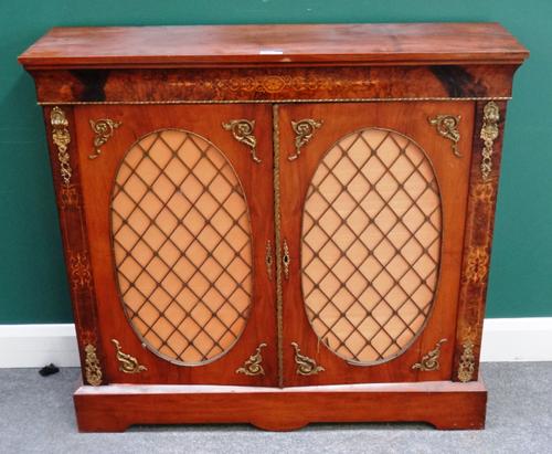A Victorian gilt metal mounted walnut and fruitwood inlaid side cabinet, with pair of grille doors on plinth base, 113cm wide x 105cm high x 31cm deep