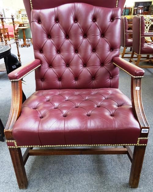 A George III style brass studded rouge leather upholstered open armchair, on channelled square supports, 72cm wide x 100cm high.