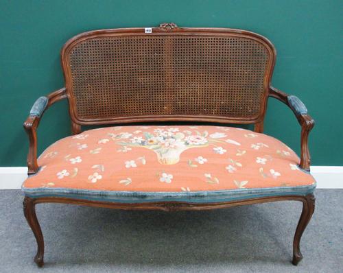 A Louis XV style stained beech open arm sofa, with serpentine seat and cabriole supports, 122cm wide x 85cm high.