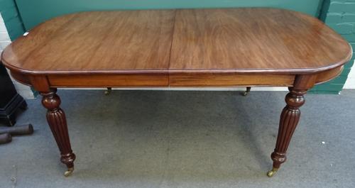 A Regency style mahogany extending dining table, on baluster reeded supports, with two extra leaves, 111cm wide x 199cm long x 299cm long extended, 78