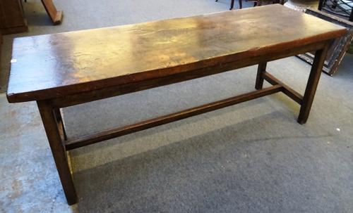 A 17th century style oak refectory table, with single slab top on square supports, 66cm wide x 190cm long, 77cm high.