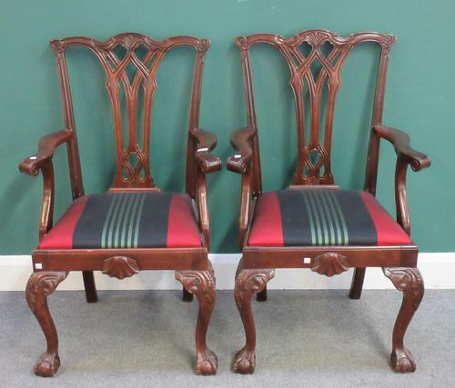 A pair of Chippendale Revival mahogany framed carver/open armchairs, with pierced splat on ball and claw feet, 60cm wide x 102cm high.
