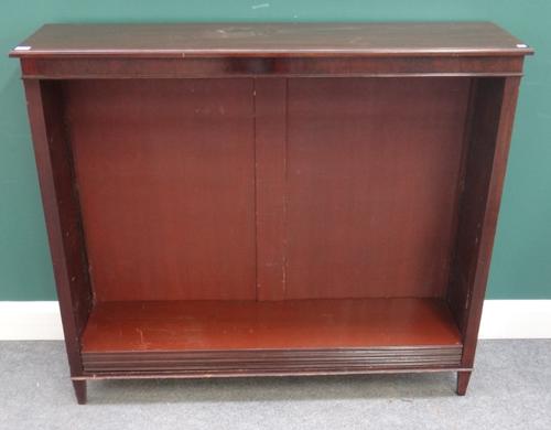 A mahogany floor standing open bookcase, on tapering square supports, 123cm wide x 108cm high x 31cm deep.