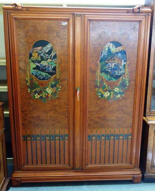 An early 20th century North European satinwood and burr elm two door side cabinet, polychrome painted with village scenes, 151cm wide x 203cm high x 4