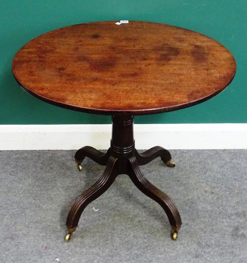A George III and later mahogany occasional table, the oval snap top on four downswept supports, 76cm wide x 69cm high.