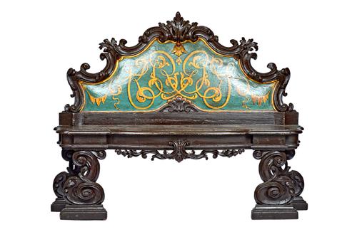 A pair of 19th century Italian polychrome painted carved walnut hall benches, each with shaped back and seat on carved silhouette supports, 165cm wide