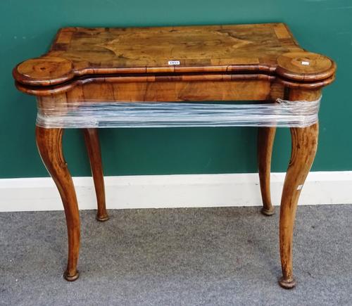 An 18th century Continental inlaid walnut card table with out stepped rounded corners on cabriole supports, 91cm wide x 75cm high x 42cm deep, (a.f).