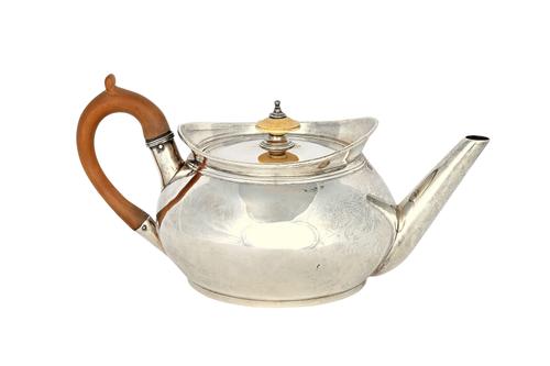 A George III silver teapot, of circular form, with a plain tapering spout, with a wooden handle and with a detachable lid, having an ivory finial, Yor