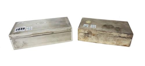 A silver cigarette box,of rectangular form,the cover and sides with engine turned decoration,monogram engraved,London,1909,makers mark for William Com