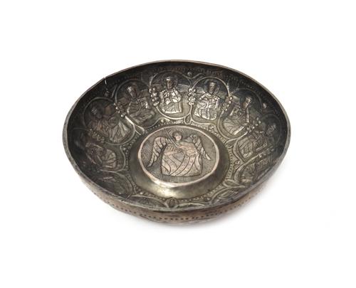 A circular bowl, the centre embossed and chased with an angelic figure and with an outer border of twelve further figures, in the Medieval Balkan tast