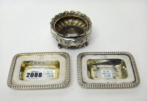 Silver, comprising; a pair of George III salt stands, each of rectangular form, having a decorated rim, crest engraved, both glass liners lacking, Lon