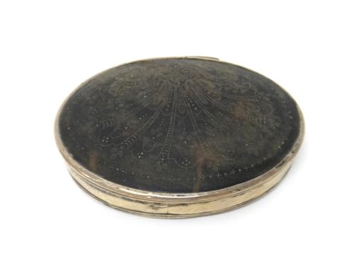 A silver mounted tortoiseshell oval hinge lidded snuff box, the lid with traces of pique decoration in a fanned design, probably first quarter of the