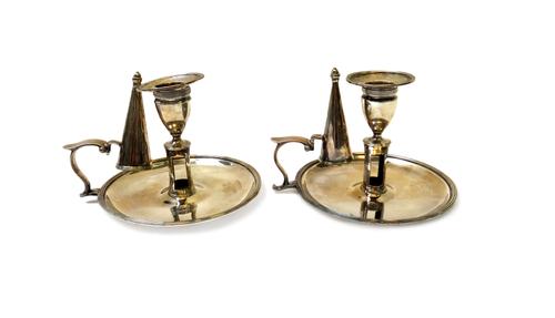 A pair of George III silver chamber candlesticks, each of circular form, within a reeded rim, with a detachable sconce and a candle snuffer (one of th