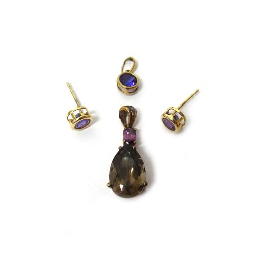 A 9ct gold, smoky quartz and rhodolite garnet set two stone pendant, claw set with a pear shaped smoky quartz below an oval cut rhodolite garnet, a pa