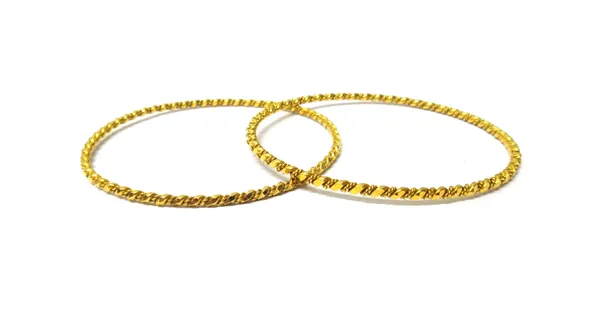 A pair of Middle Eastern gold circular bangles, each in a faceted ropetwist wirework design, combined weight 24.6 gms, (2).