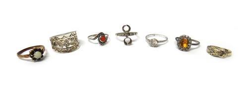 A diamond set ring mount, mounted with five cushion shaped diamonds and with the principle diamond mounted at the centre, three gold and gem set rings