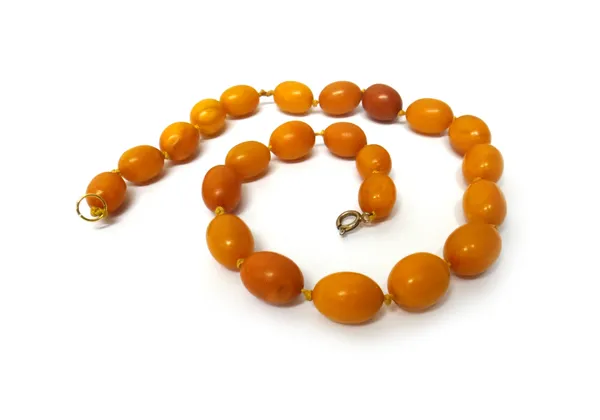 A single row necklace of uniform vary coloured oval butterscotch coloured amber beads, on a boltring clasp, length 48.5cm, gross weight 44 gms.